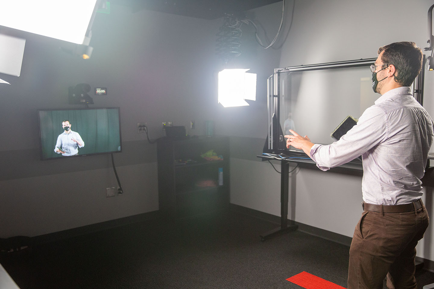 Photo of an instructor recording a lecture in the video studio in Denney Hall Digital Union