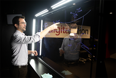An instructor uses the lightboard in the Denney Hall Digital Union Studio