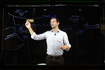 An instructor uses the lightboard in the Denney Hall Digital Union Studio